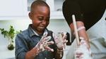 Boy cooking with sticky fingers. Family meal plans and activities were key F&R initiatives during lockdown.