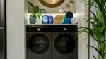 Persil and Comfort Smart Series laundry detergent and conditioner sitting on top of Samsung smart auto-dose washing machine.