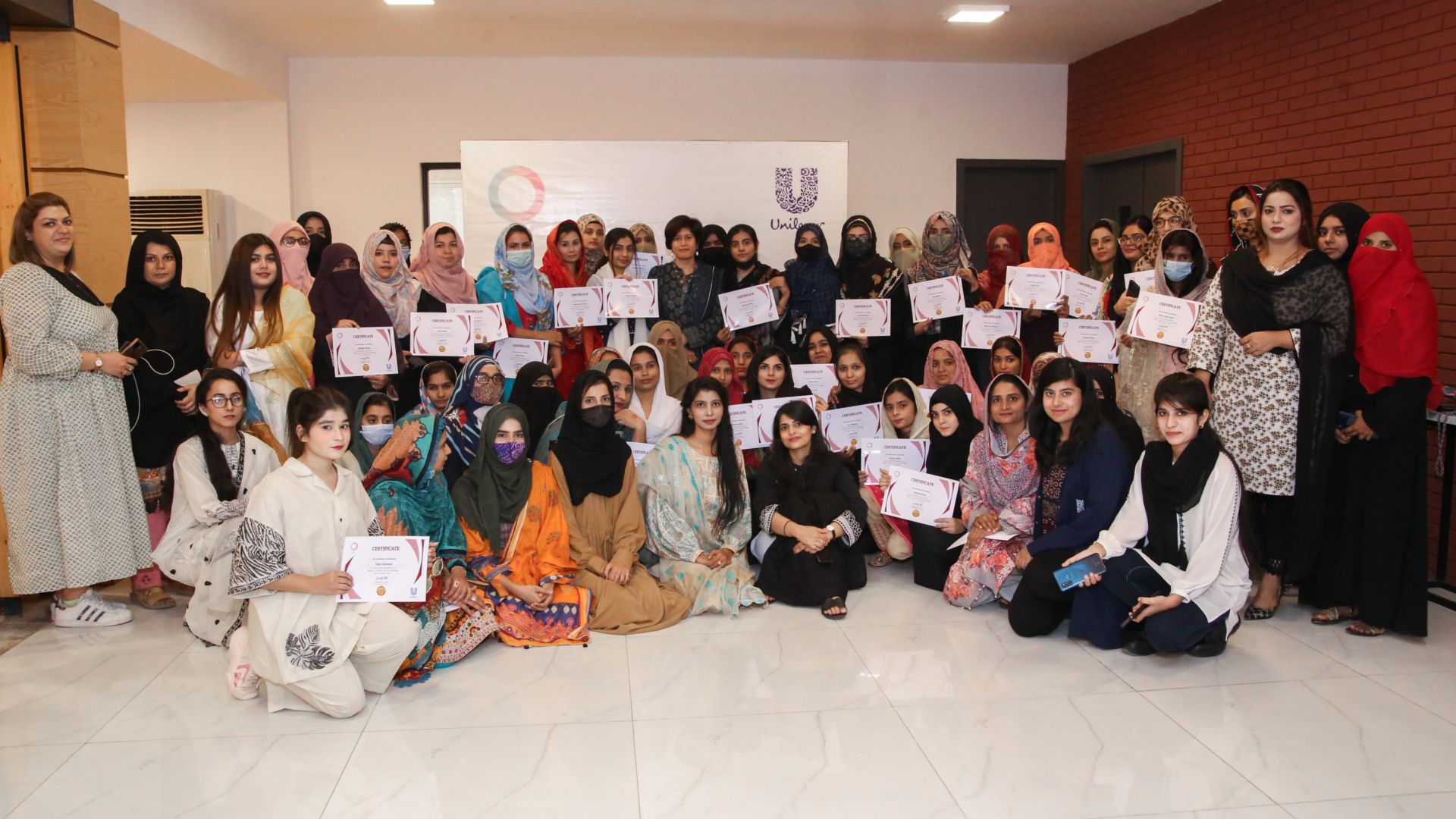 Group of girls holding a certificate.