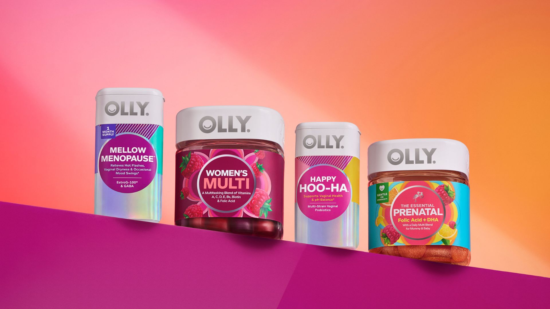 Four Olly vitamin products line up against a purple and peach background with a spotlight on them.