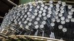 Multiple aluminium cans on a production line.