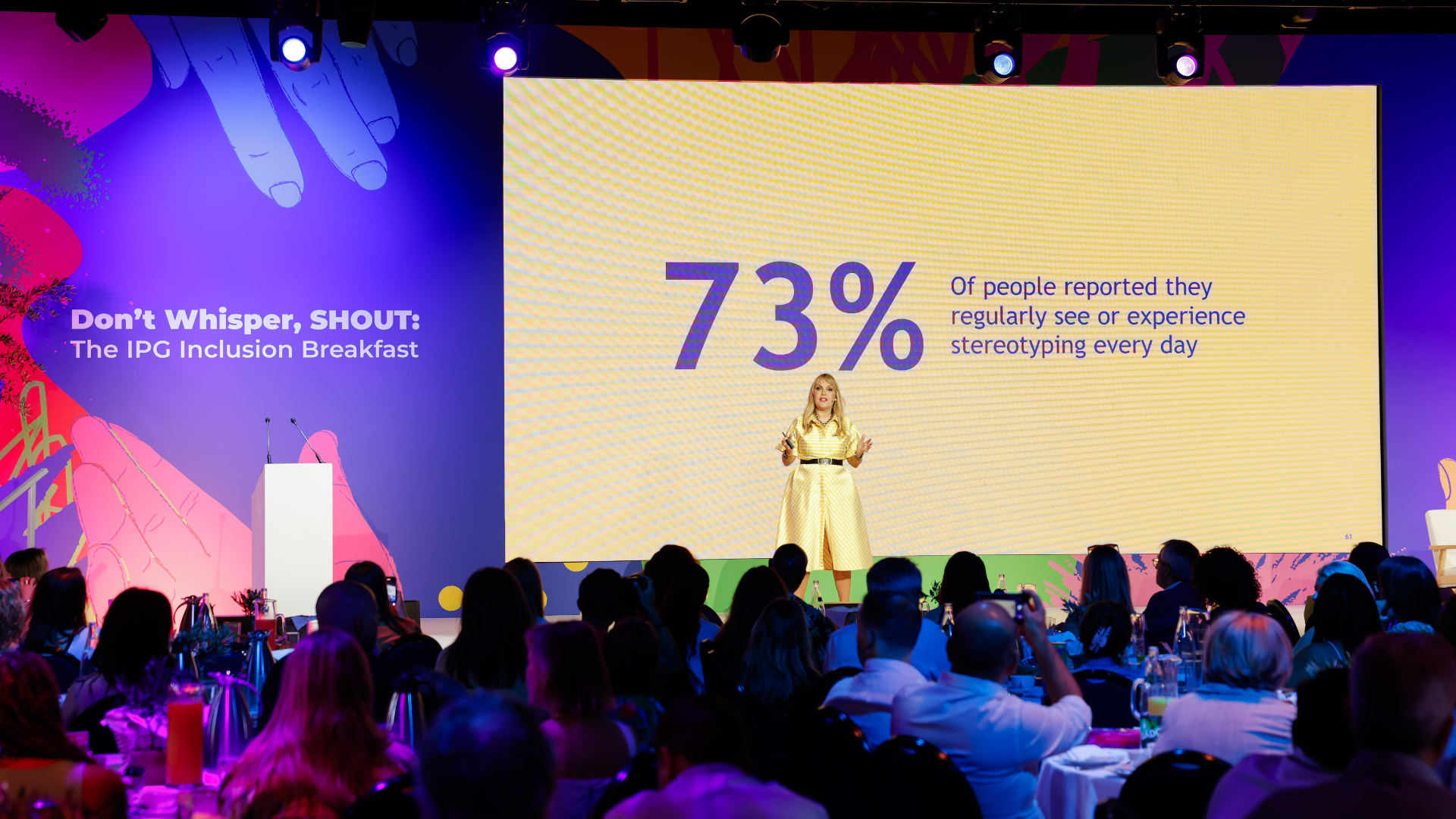 Aline Santos on stage with background stat that 73% of people encounter stereotyping 