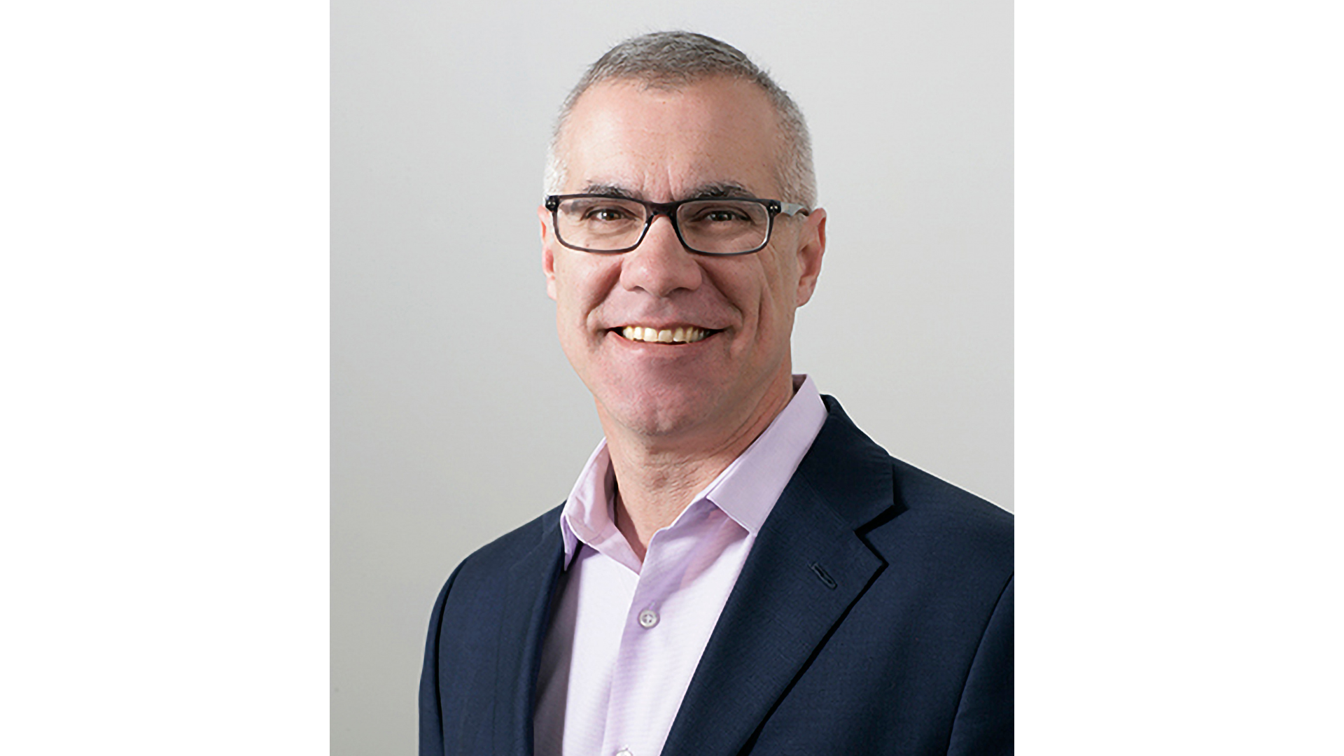 A photo of Steve McCrystal, Unilever Chief Enterprise and Technology Officer. He is a white man, wearing glasses, smiling at the camera