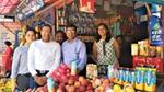 Group of people standing at a market stall for the launch of Horlicks in Nepal.