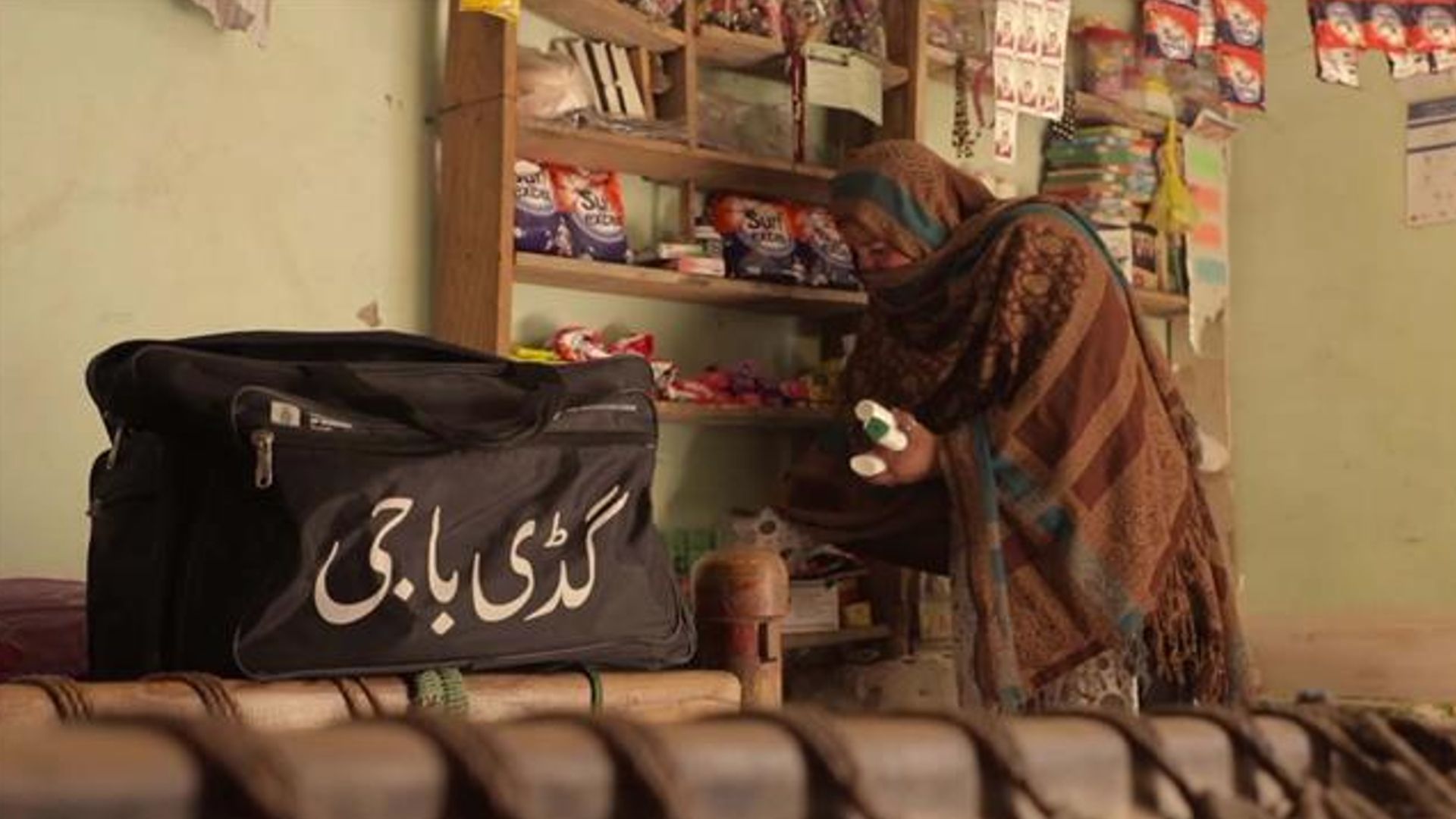 A rural representative of "Guddi Baji" program loading products in her basket bag.