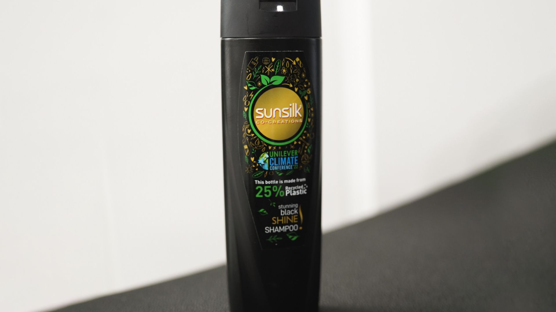 Black Recycled Sunsilk shampoo bottle. 