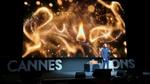 Leandro Barreto on stage at Cannes Lions delivering his keynote speech in front of a photo of a flames.