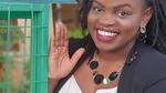 Unilever employee, Draganah Omwange stands next to a recycling bin, part of the initiative she set up.