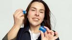 A photo of creator Lauren Luke holding the Vaseline Originals Primer & Highlighter product she helped design.