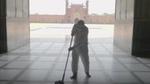 Man mopping the entrance to a large building, using Domestos