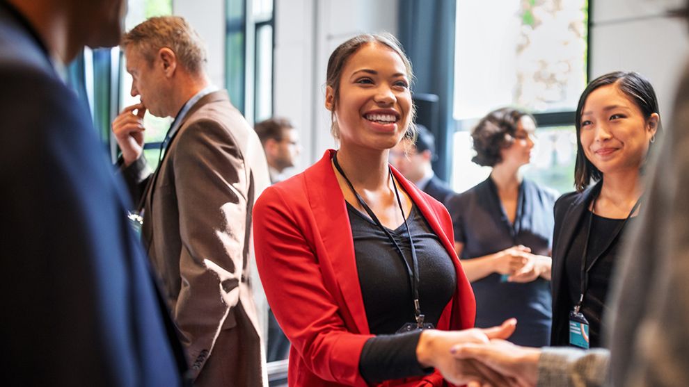 Businesswoman shaking hands. In 2020, Unilever reached its target of 50% of all managerial roles being held by women.